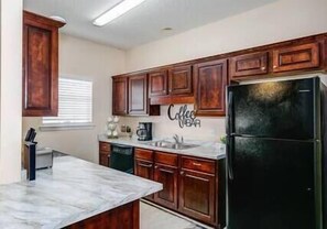 Enjoy cooking in this well-equipped kitchen with a coffee bar and convenient countertop space.