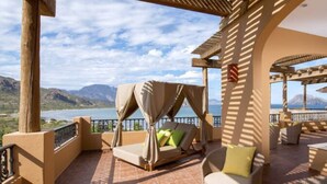 A terrace with a view of a lake and mountains, featuring outdoor seating and a hot tub. - PERFECT OASIS with private beach, golf course, kayaking, snorkeling +more (Loreto)