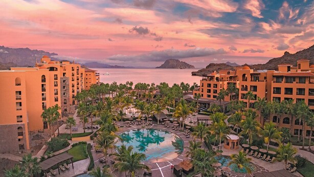 A resort with multiple buildings, a central pool, and palm trees. - PERFECT OASIS with private beach, golf course, kayaking, snorkeling +more (Loreto)