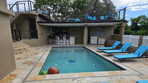 A swimming pool with lounge chairs, a hot tub, and a covered seating area. - 2BR Modern Golden Pear Villa, Pool, Wi-Fi, Kitchen, Views – Family/Group Ready (Saint David)