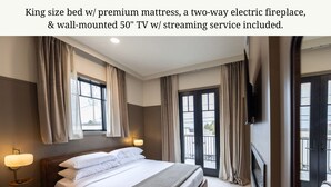 A king-size bed with a premium mattress, a two-way electric fireplace, and a wall-mounted 50" TV with streaming service included. - Luxury Suite Downtown Berlin 302 (Millersburg)