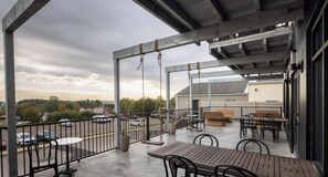 A large deck with outdoor seating and a view of the parking lot.