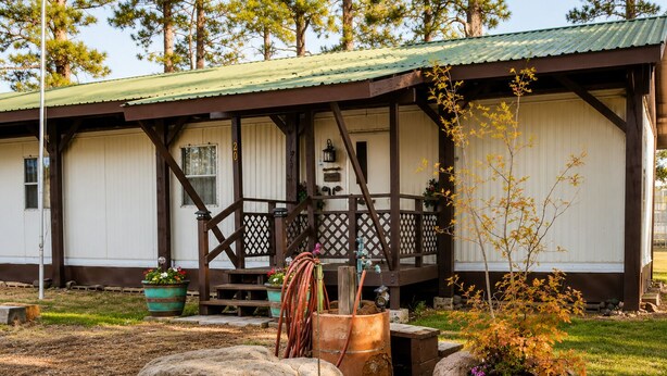 A rustic cabin with a porch, wooden beams, and a metal roof. - Quiet Escape for Hunters & Family Retreats! (Alpine)