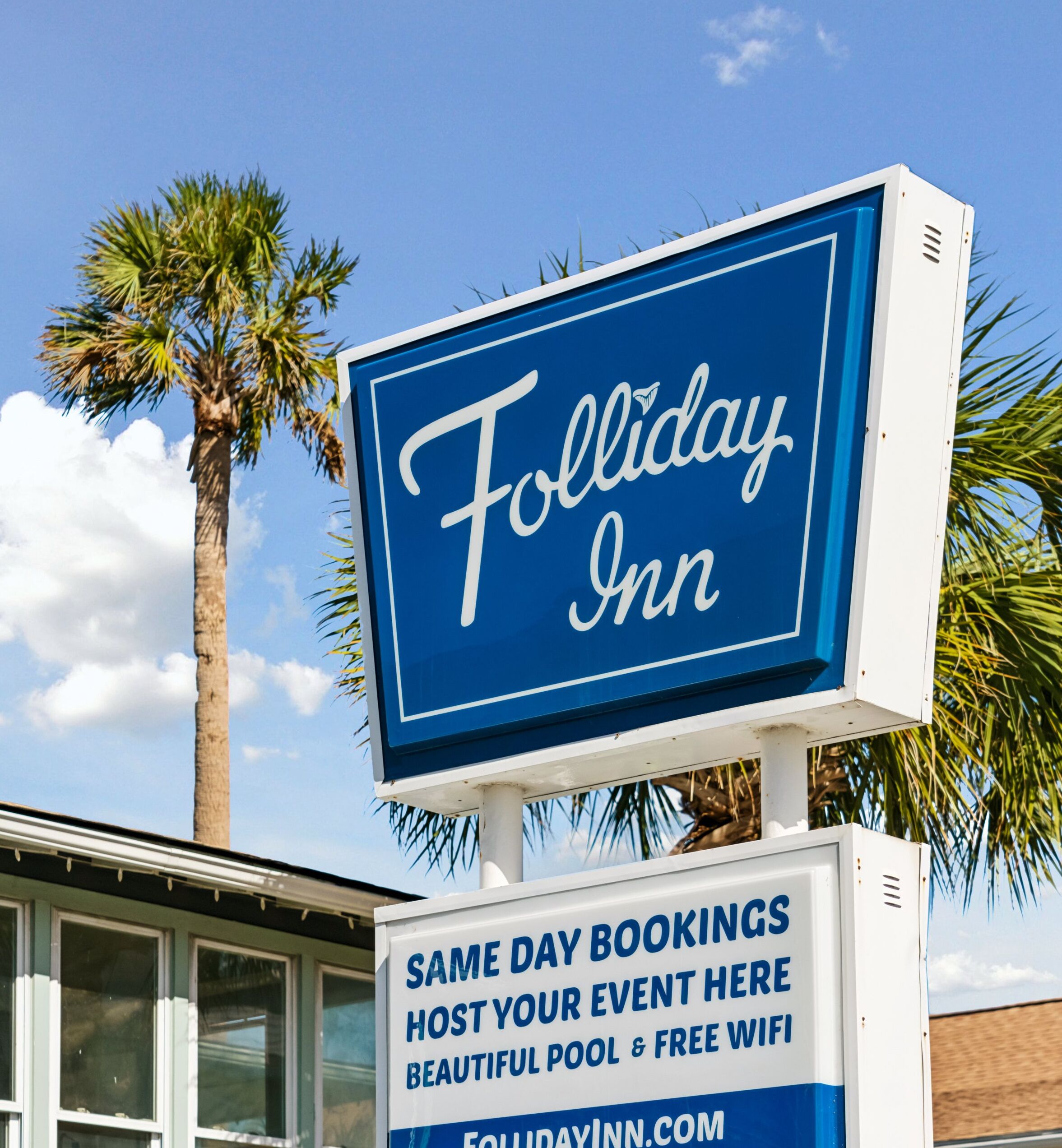 A sign for the Holiday Inn with text advertising same day bookings, a beautiful pool, and free wifi.