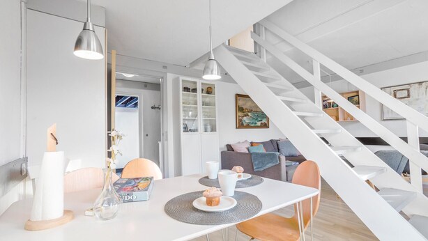 A modern living space with a dining area, white furniture, and a staircase. - Awesome apartment in Allinge with WiFi (Allinge)