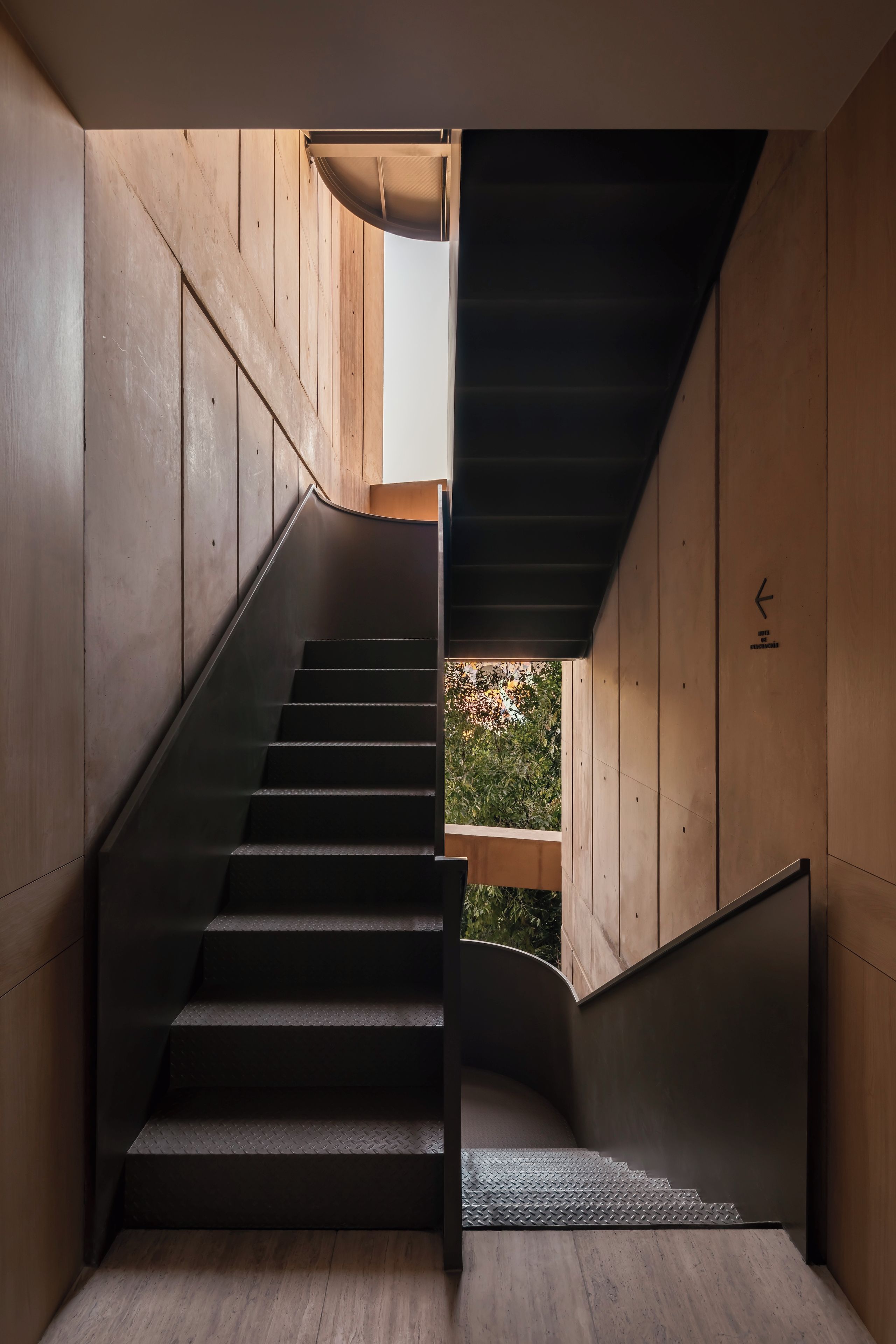 A staircase with a modern design, leading to an outdoor area.