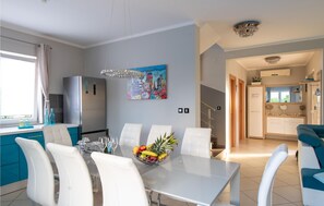 Enjoy a comfortable dining experience in this stylish space with a large table for four, an oven, and a microwave.
