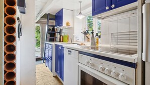 A modern kitchen with blue cabinets, a Siemens dishwasher, and a built-in oven. - 3 bedroom gorgeous home in Nexø (Nexø)