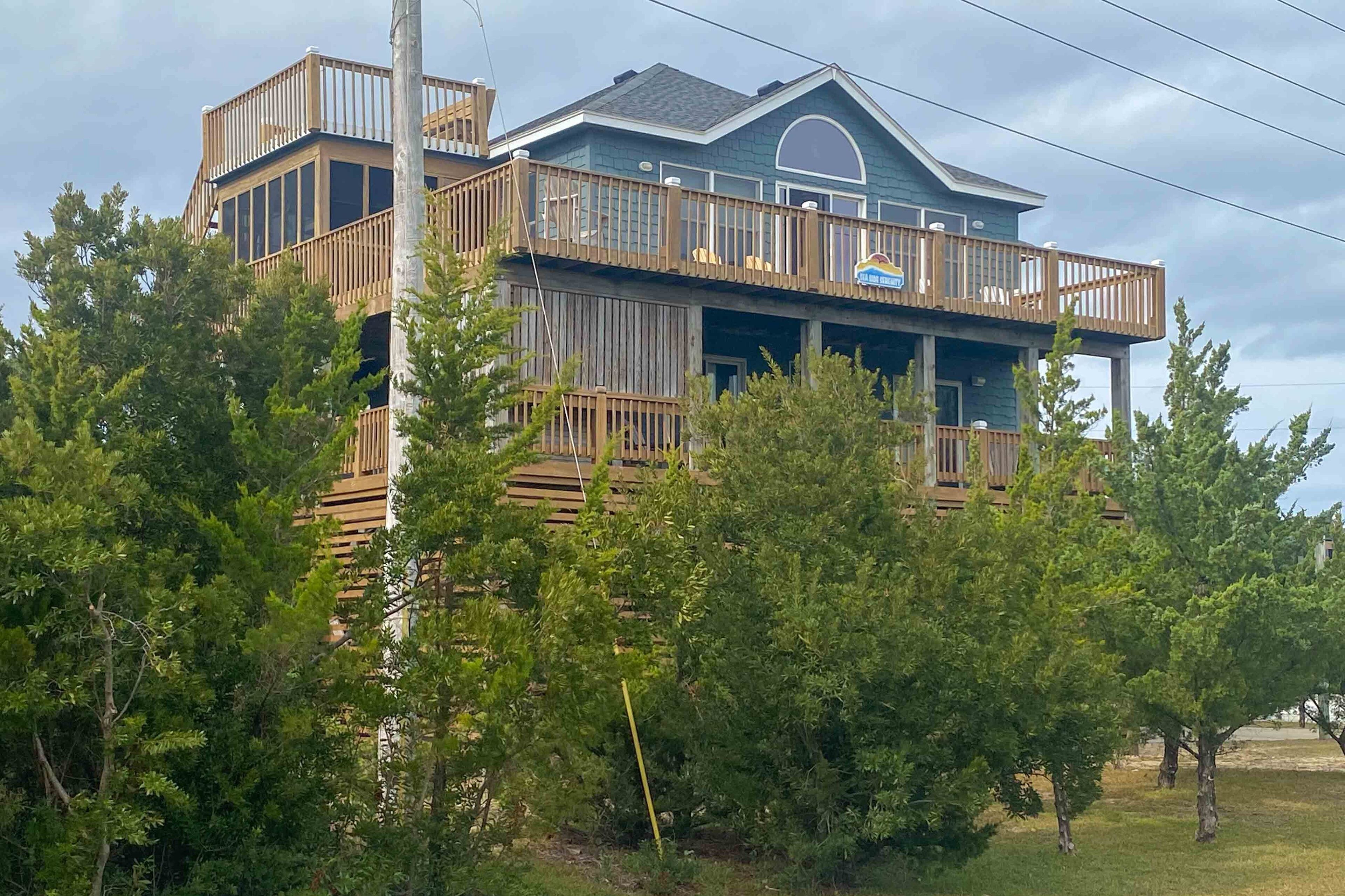 A two-story house with a balcony and a covered porch.