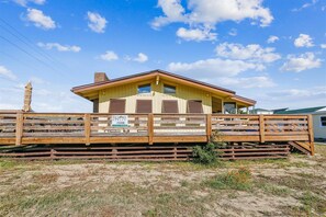 Guests can enjoy a front porch with a railing at this single-story property.