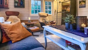 A cozy living room with a sofa, armchair, and a coffee table. - Nice home in Follafoss with lake view (Follafoss)