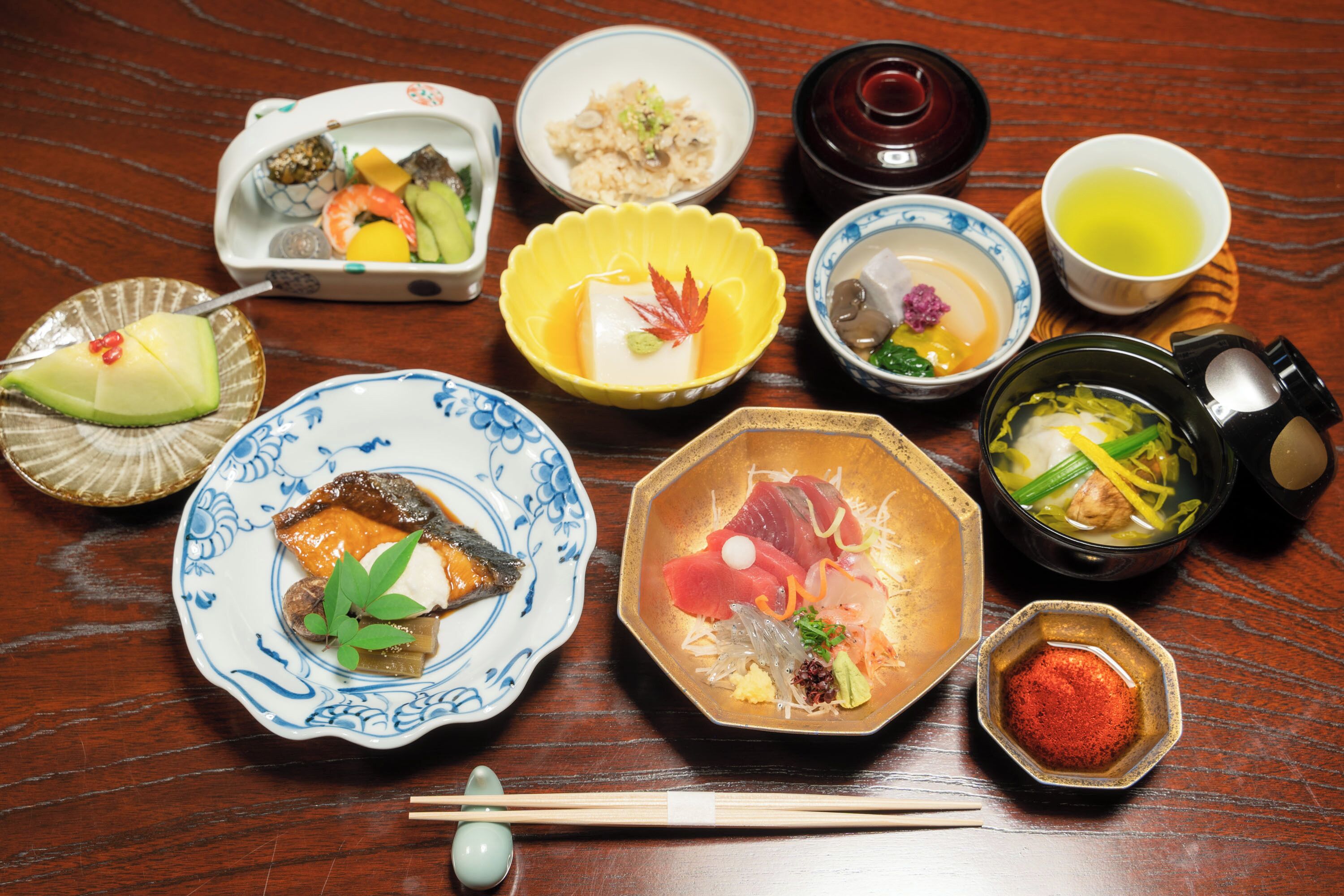 A variety of Japanese dishes on a wooden table.