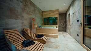 A modern spa room with wooden loungers, a large mirror, and a separate shower area. - Cozy home in Cista Velika with sauna (Cista Velika)