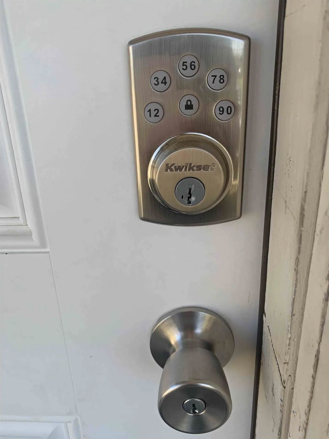 A door with a numeric keypad and a keyhole lock.