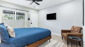 A bedroom with a bed, a ceiling fan, a TV, a chair, and a window with blinds. - Sequoia Motel King RM6, AC, Pool, WiFi 10 Min SNP (Three Rivers)