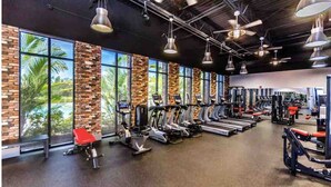 A gym with treadmills, stationary bikes, and weight machines.