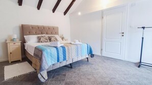 A bedroom with a bed, nightstand, and a door. - Didini Dvori in Kru evo (Obrovac)