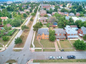 An aerial view of a residential area with houses, streets, and a church.