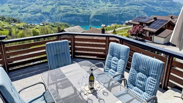 A terrace with a table and chairs overlooking a mountainous landscape. - Penthouse Brugg by Interhome (Amden)