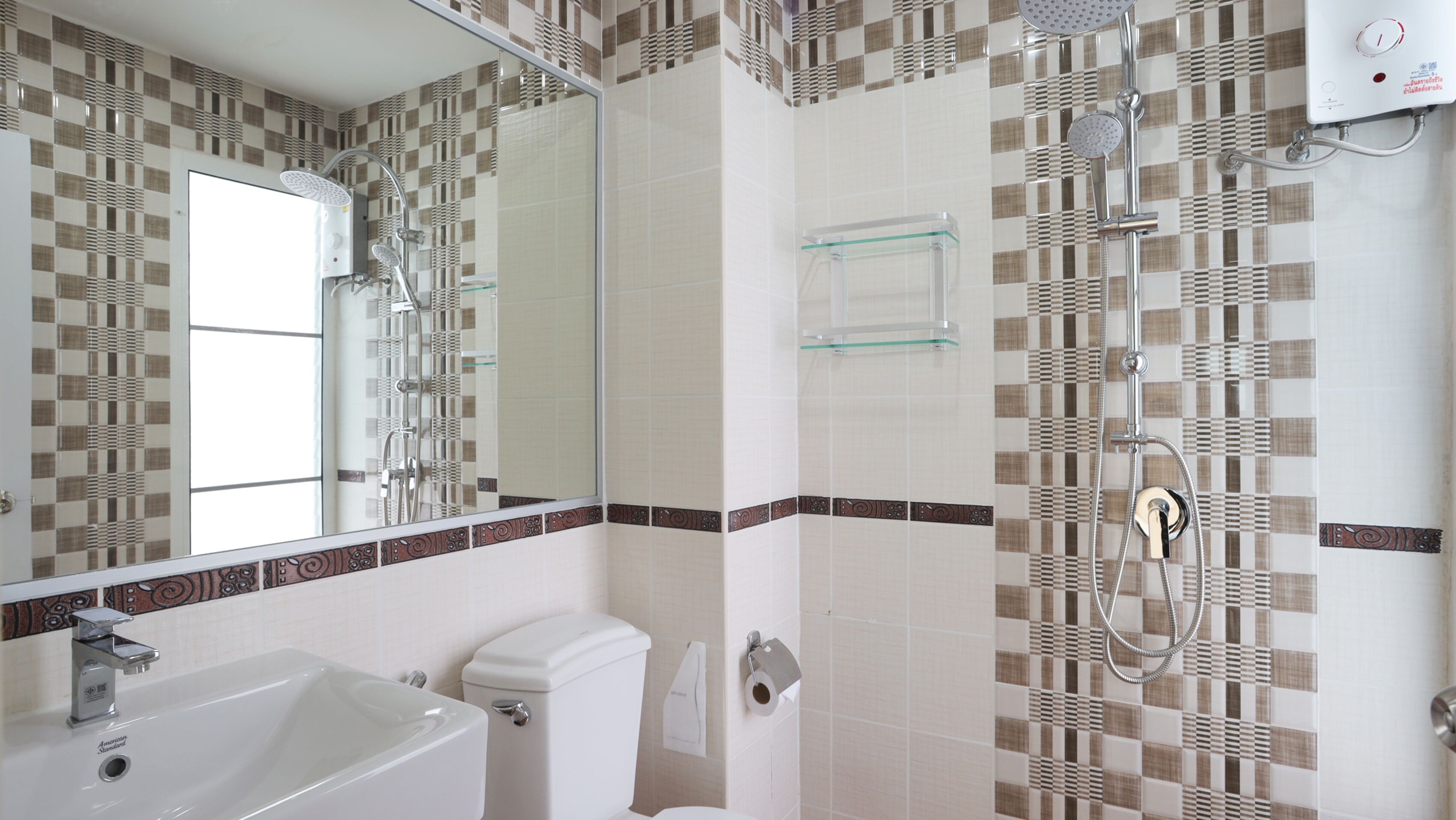A bathroom with a shower, toilet, and sink.