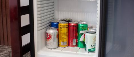 A refrigerator with multiple beverage cans.