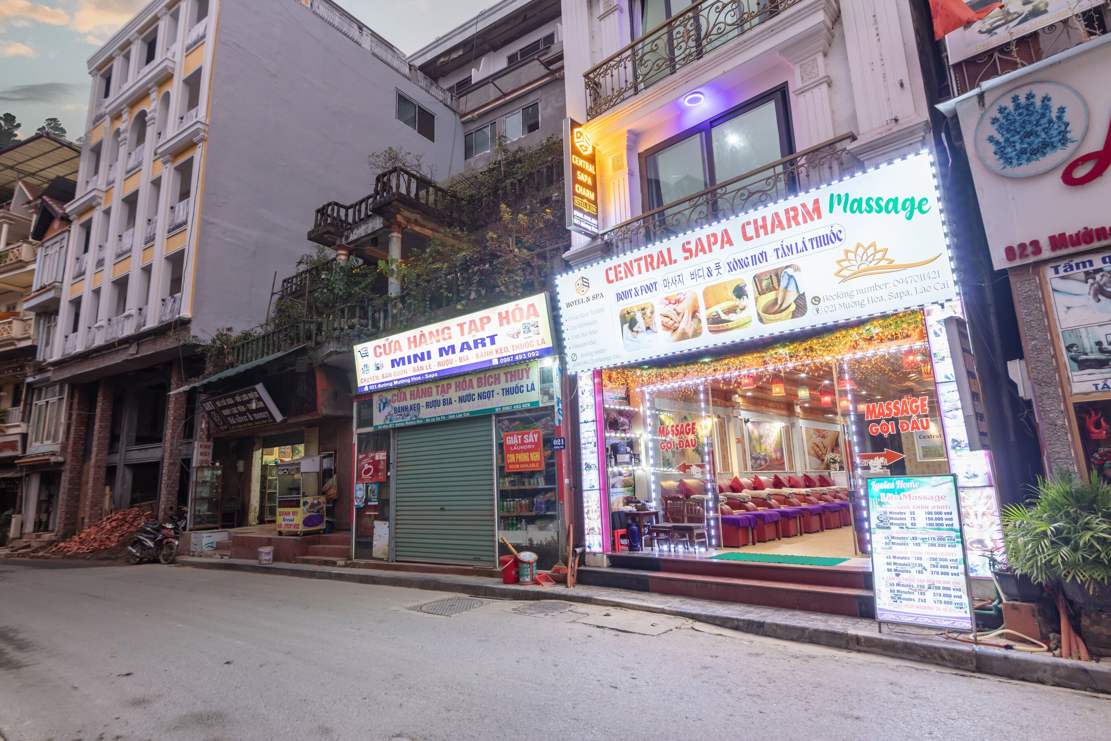 A street view with various shops, including a massage parlor and a mini mart.