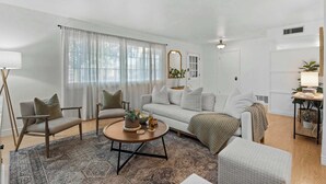 A living room with a sofa, chairs, a coffee table, and a lamp. - Boho Chic, Mtn Preserve Hike, Pool, & Grille! (phoenix)