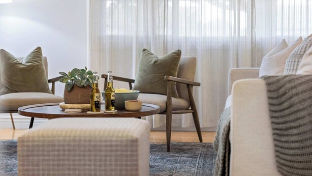 A cozy living room with a round coffee table, two armchairs, a sofa, and a potted plant. - Boho Chic, Mtn Preserve Hike, Pool, & Grille! (phoenix)