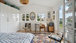 A bedroom with a bed, a desk, two chairs, a window, and a wardrobe. - 3 bedroom gorgeous home in Assens (Assens)