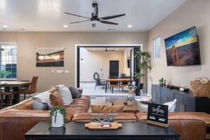 A modern living room with a leather sofa, a coffee table, and a sign that reads "relax."