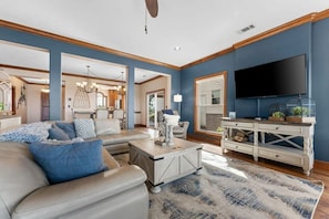 A modern living room with a sofa, coffee table, and TV.