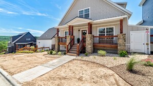 A two-story house with a front porch, a staircase, and a driveway. - Lake Access, Hot Tub, Pools, Paddleboard, Sleep 20 (Hollister)