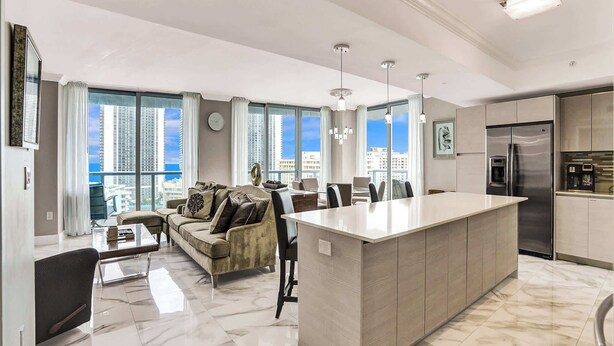 A modern apartment with a large living area, a dining space, and a kitchen.