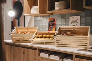A bakery display with wooden crates of pastries and a sign about fruit cake.