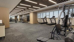 A gym with treadmills, weight machines, and dumbbells. - Novotel Yancheng Exhibition Center (Yancheng)