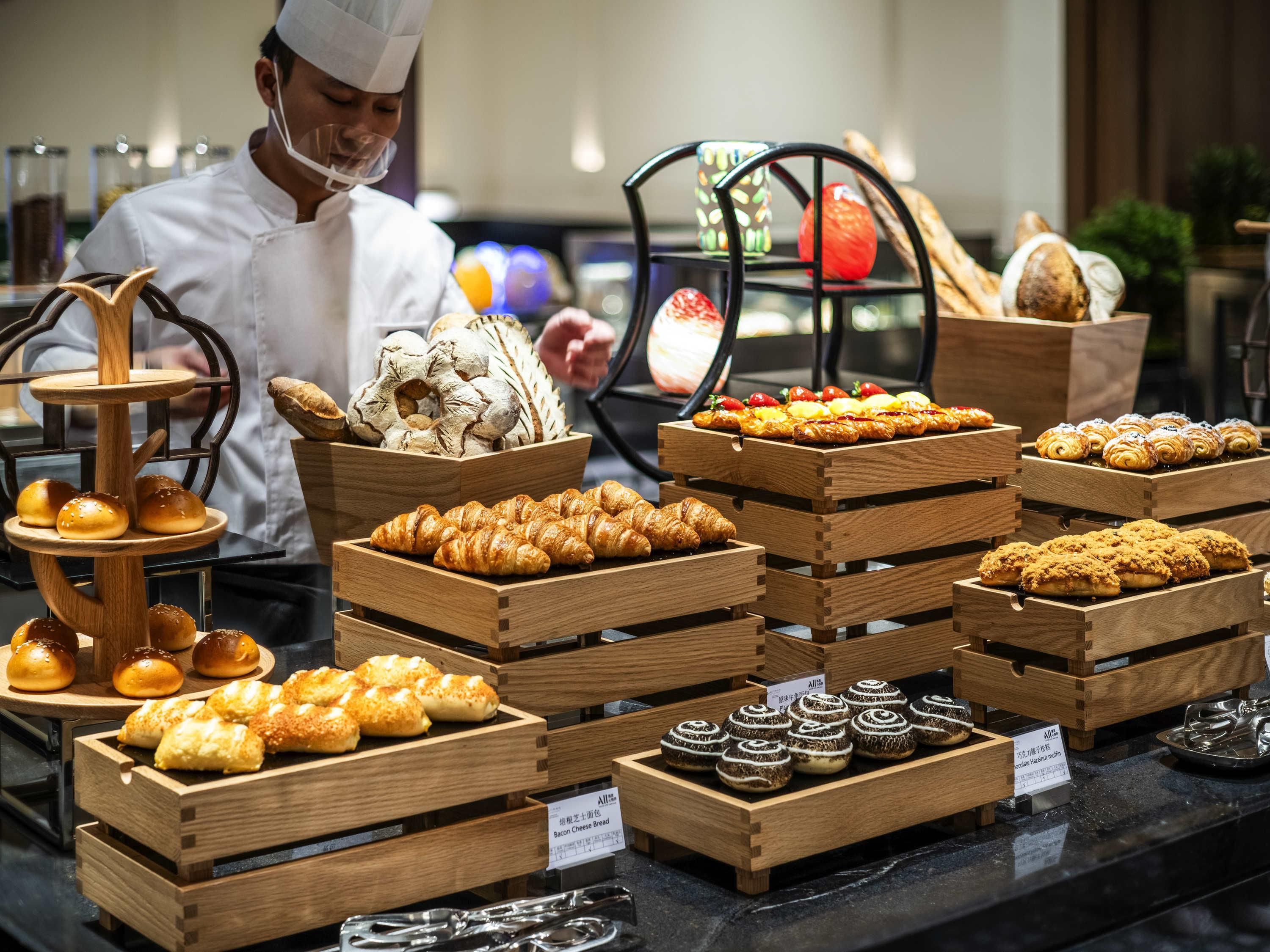 A bakery display with various baked goods in wooden crates.