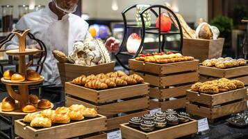 A bakery display with various baked goods in wooden crates.