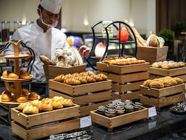 A bakery display with various baked goods in wooden crates.