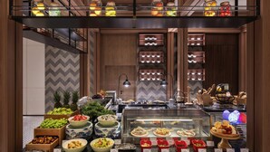 A buffet area with various food items and a display of fruits and vegetables. - Pullman Quanzhou Shuitou (Quanzhou)