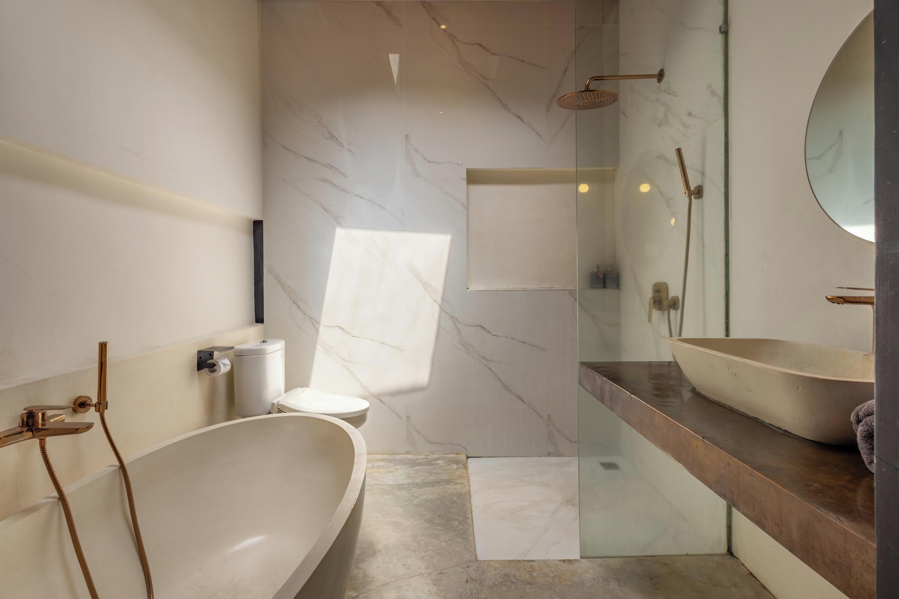 A modern bathroom with a freestanding bathtub, a glass-enclosed shower, and a large mirror.