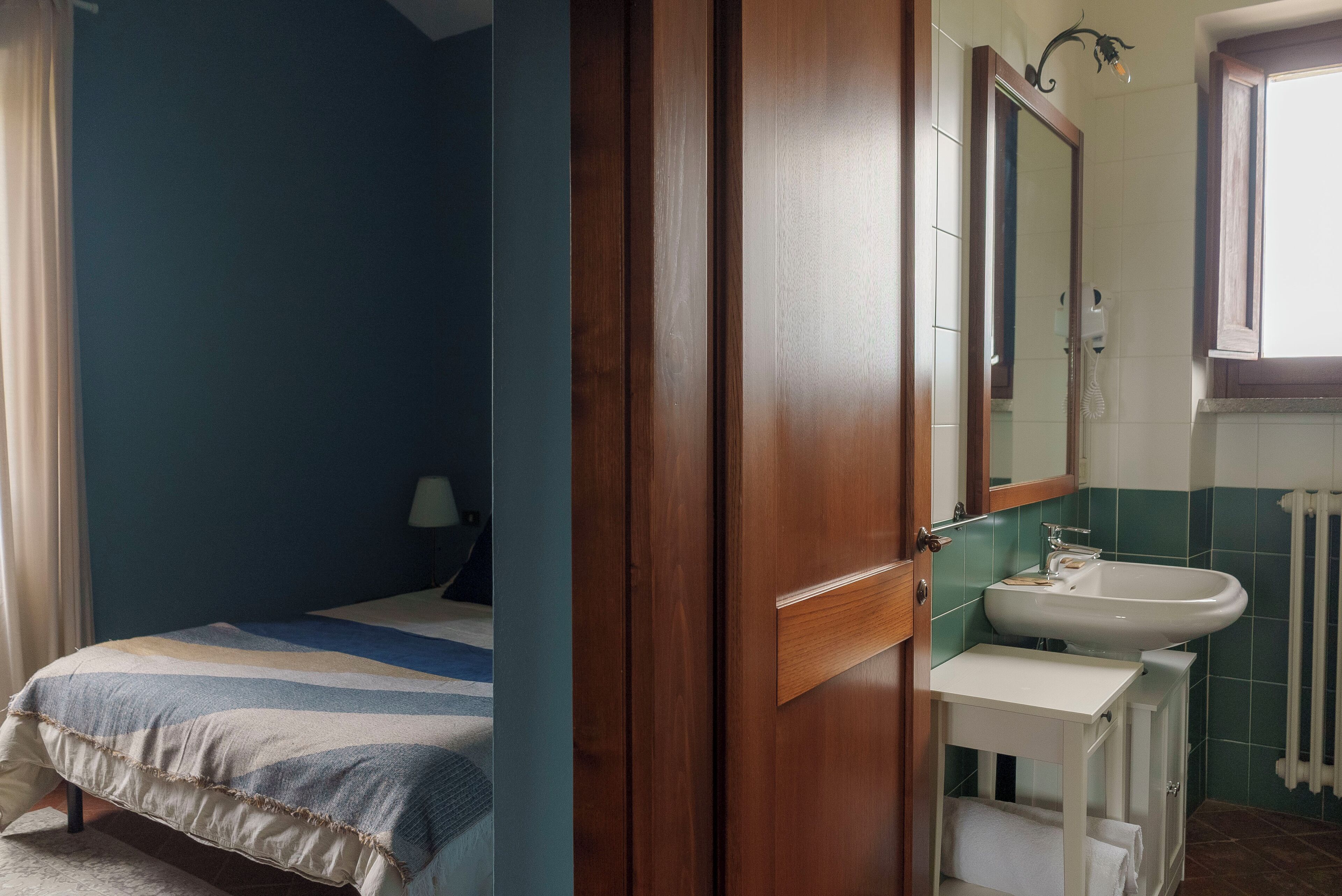 A bedroom with a bed, a bedside table, and a nightstand.
