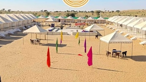 A desert safari camp with multiple tents and a sandy landscape. -  Barkha Desert Safari Camp Sam Sand Dunes (Jaisalmer)