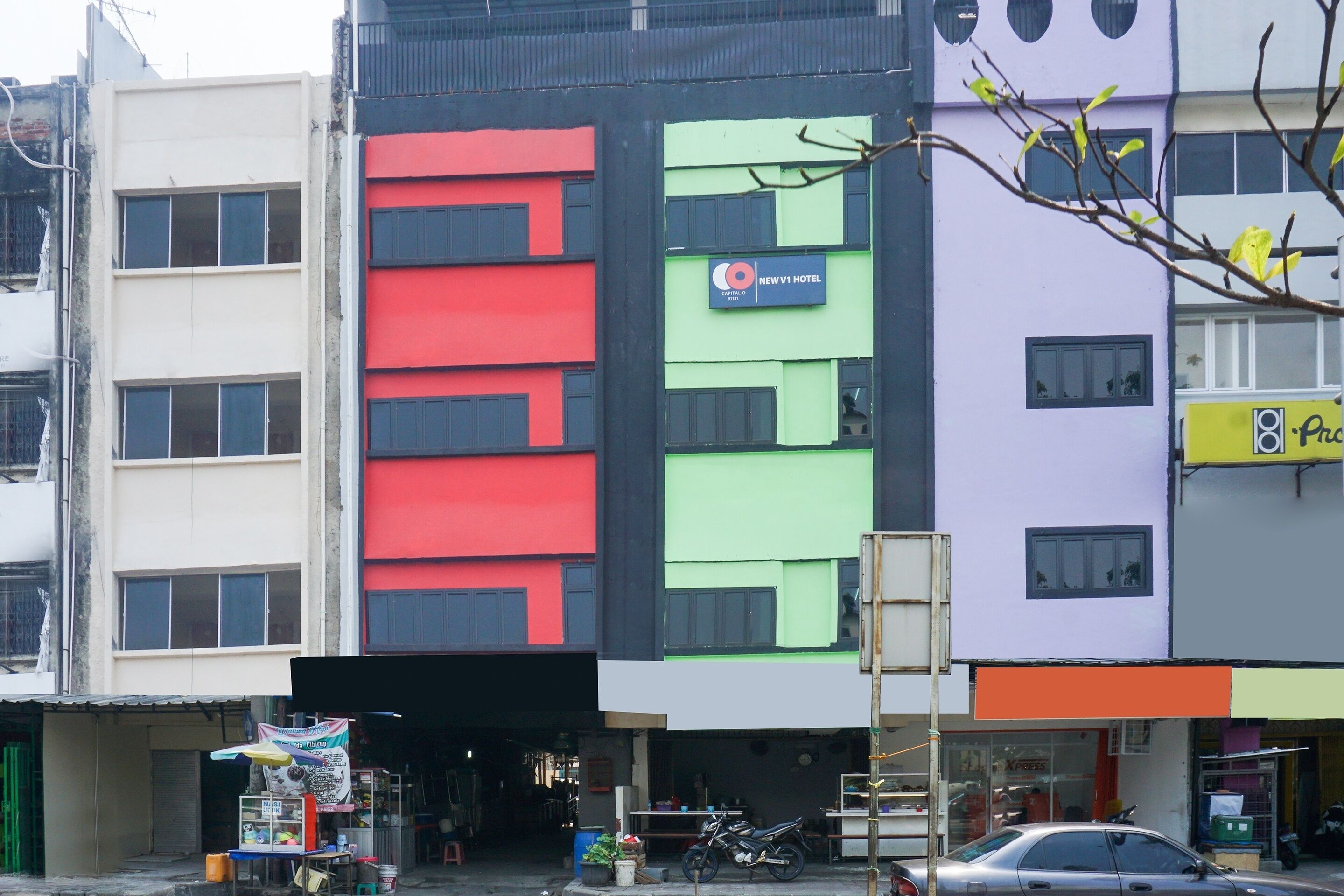 A multi-story building with a sign for 'New V1 Hotel'.