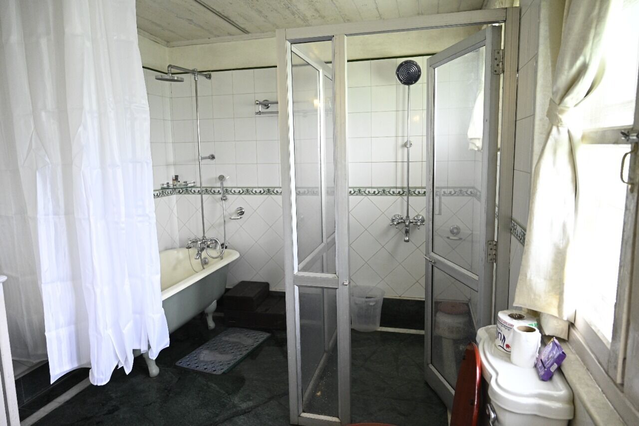 A bathroom with a bathtub, a shower, and a toilet.