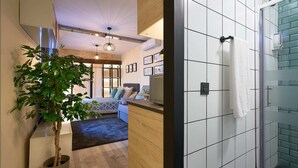 A modern bathroom with white tiles and a glass shower enclosure. - Castilla 75, Urban Loft 1st floor (Sevilla)