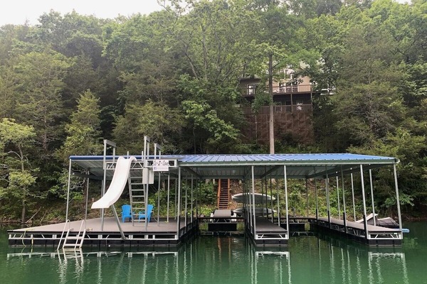 Dock with jumping platform, slide, 2 covered slips, 2 jet ski ports.