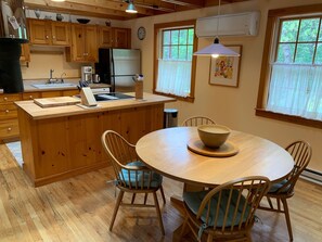 Enjoy meals in this well-equipped kitchen and dining area with a sink, coffee maker, and comfortable seating for four.