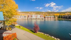 A lakeside hotel with multiple buildings, a dock, and a clear view of the lake.