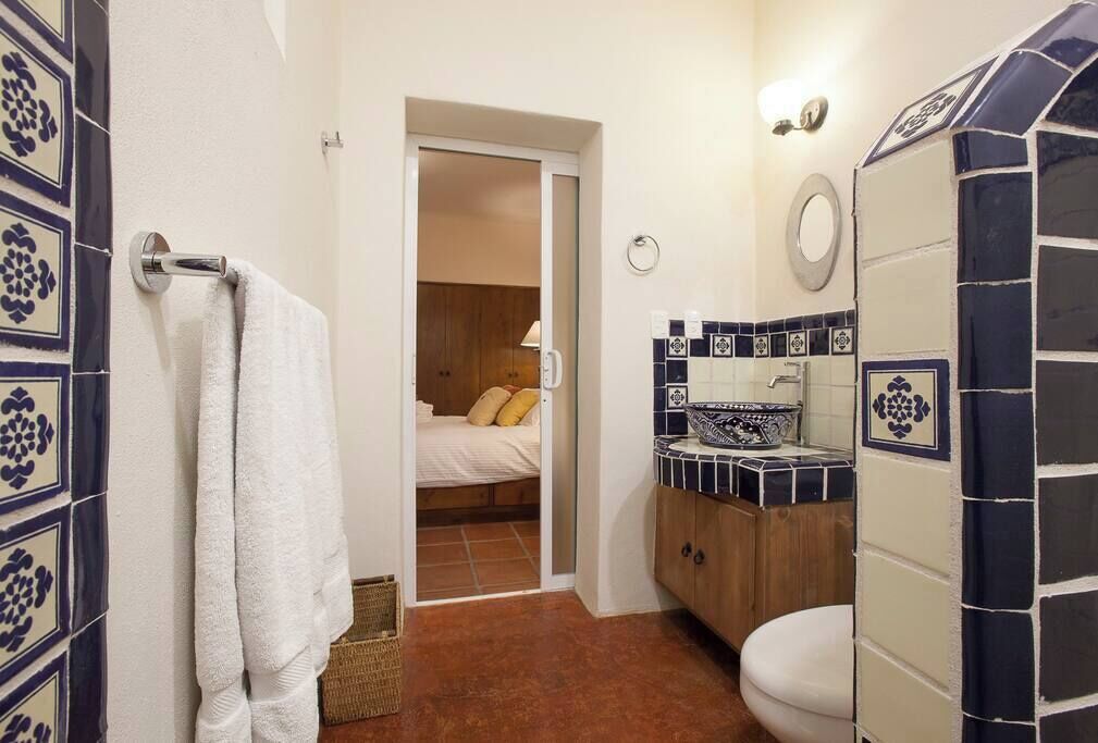 View into the main bedroom from its connected full bath.