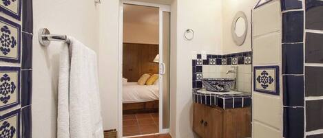 View into the main bedroom from its connected full bath.